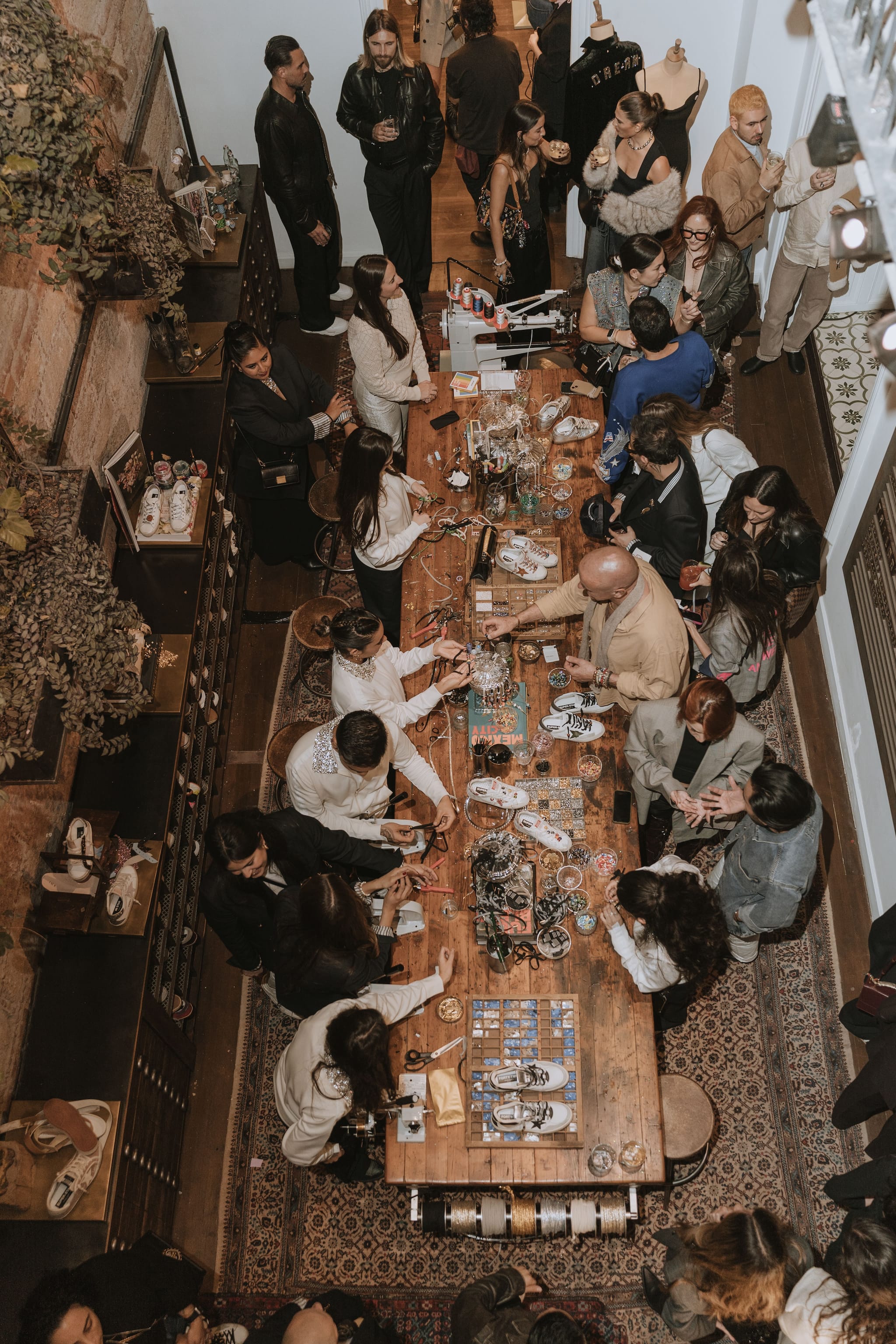 Overhead view of attendees gathered around central workshop table during Haus Mexico city opening event
