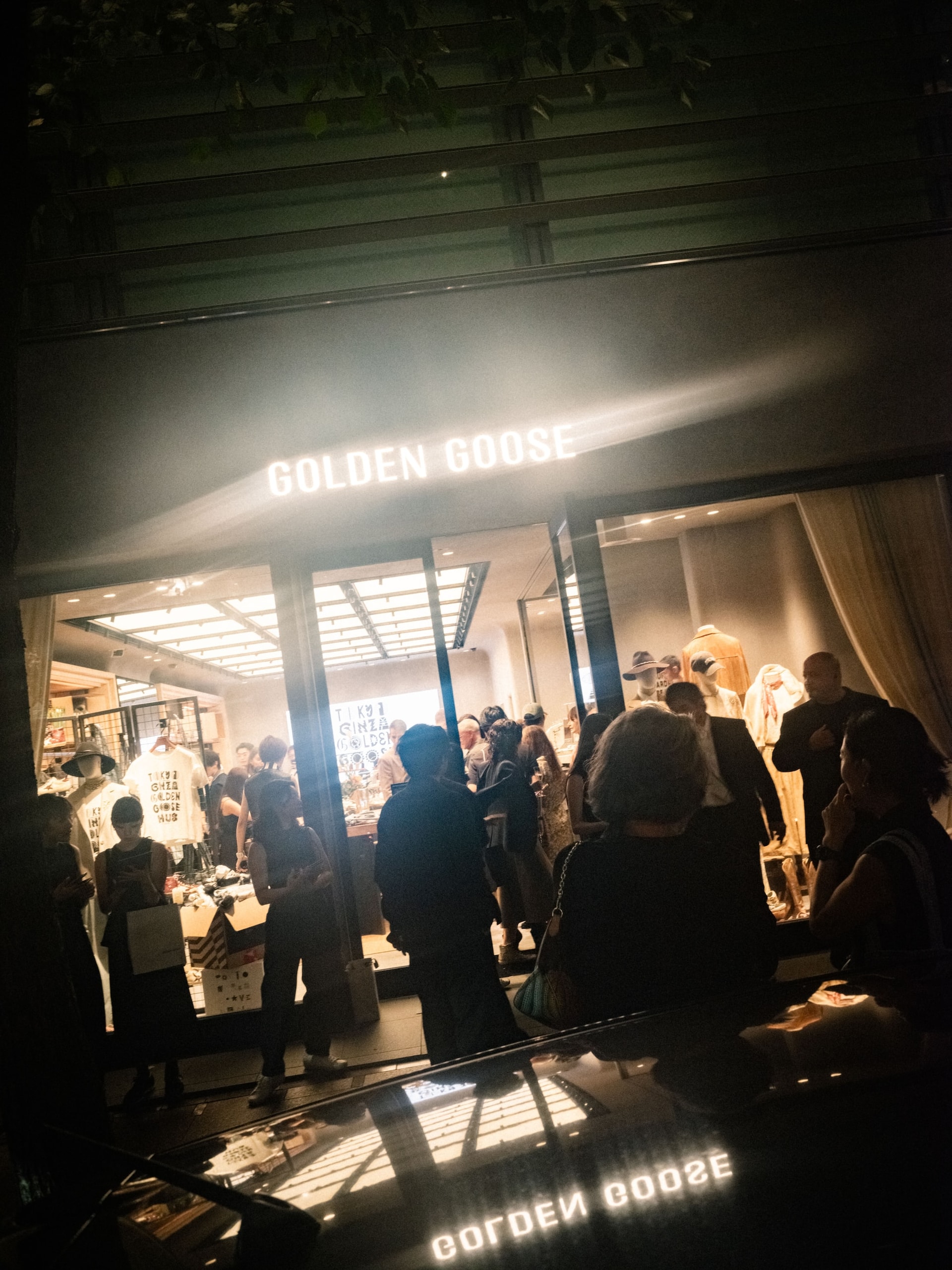 Brightly lit Golden Goose store facade at night in Ginza during Tokyo Haus showcase