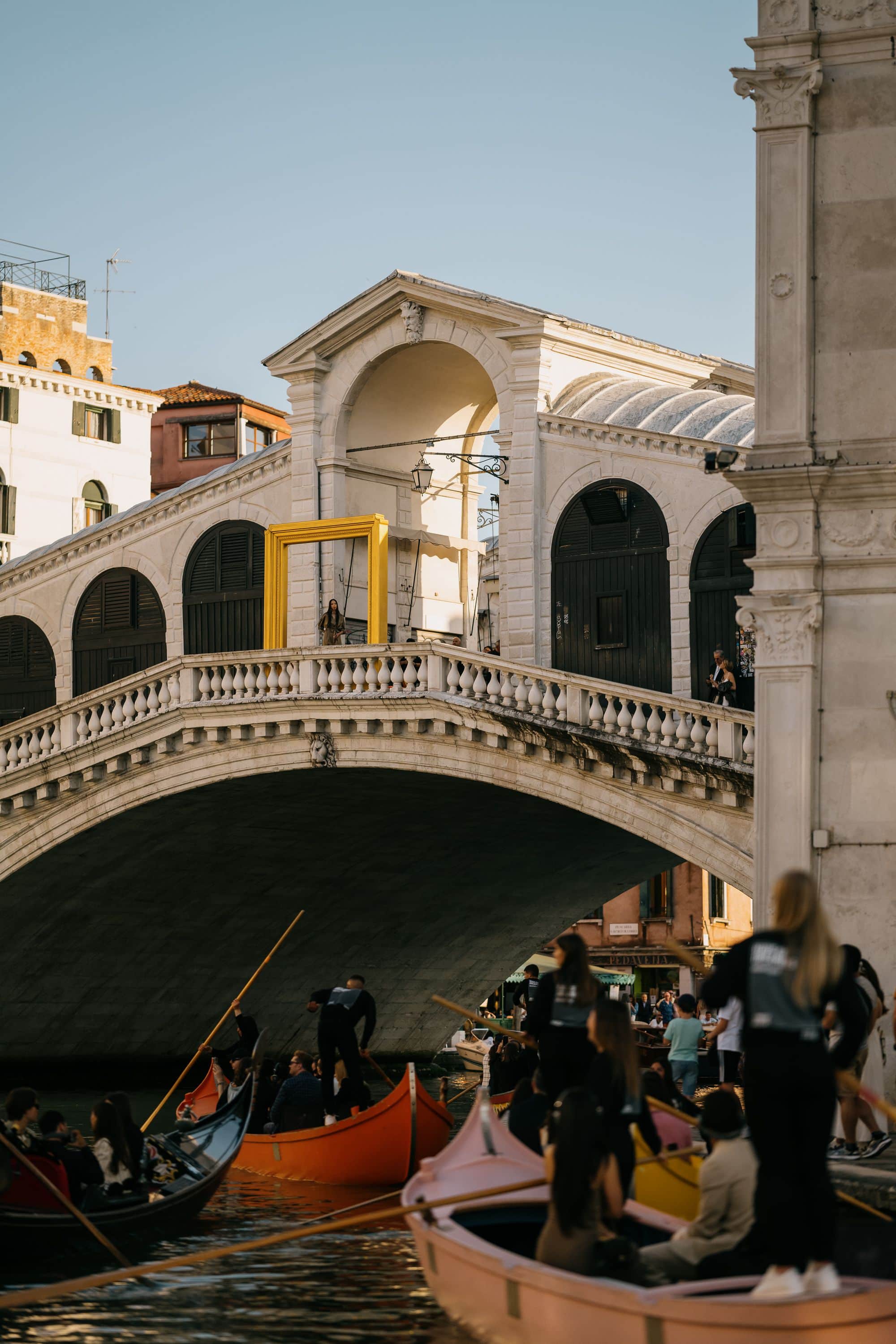 Gondolas floating on water under historic Rialto bridge during Venice Haus tour
