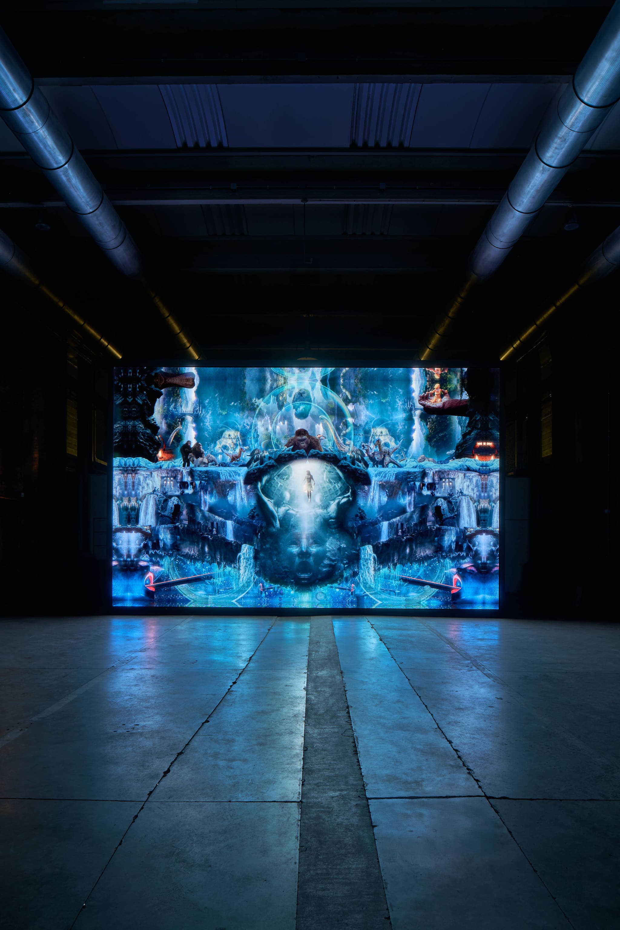 Large screen displaying vibrant surreal digital collage in industrial hall at Haus event