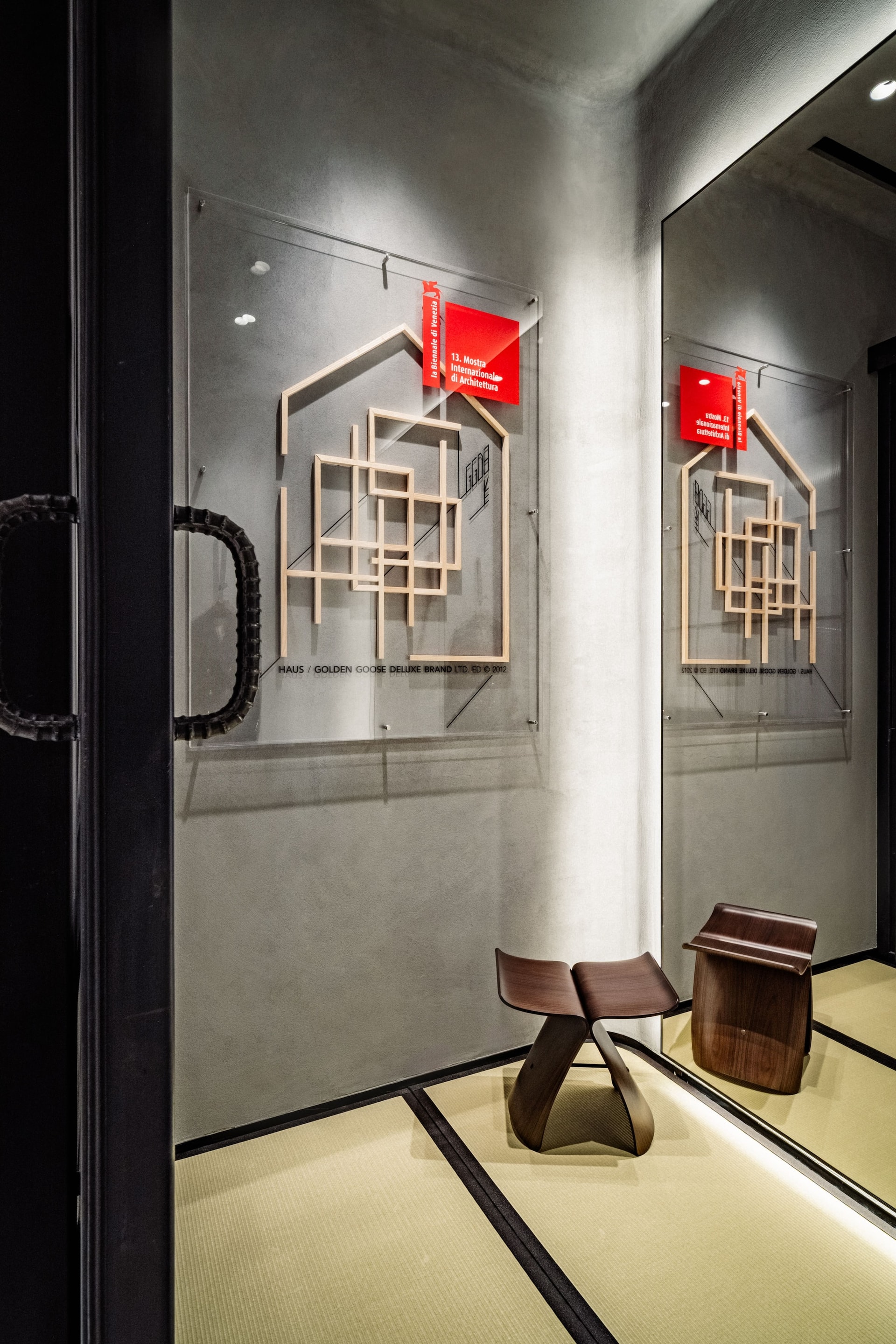 Architectural wall installation and wooden stool on tatami mats during at Tokyo haus